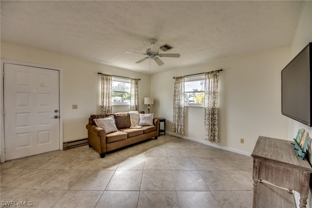5892 Sailfish Road Bokeelia, FL 33922 - Photo 18 of 32 a living room with furniture and a flat screen tv