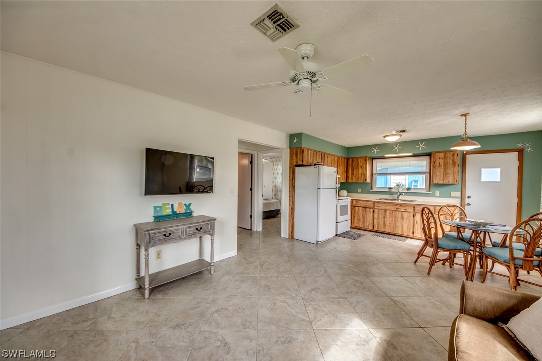 5892 Sailfish Road Bokeelia, FL 33922 - Photo 19 of 32 a living room with furniture and a flat screen tv