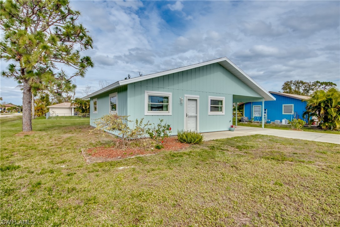 5892 Sailfish Road Bokeelia, FL 33922 - Photo 2 of 32 a backyard of a house with table and chairs