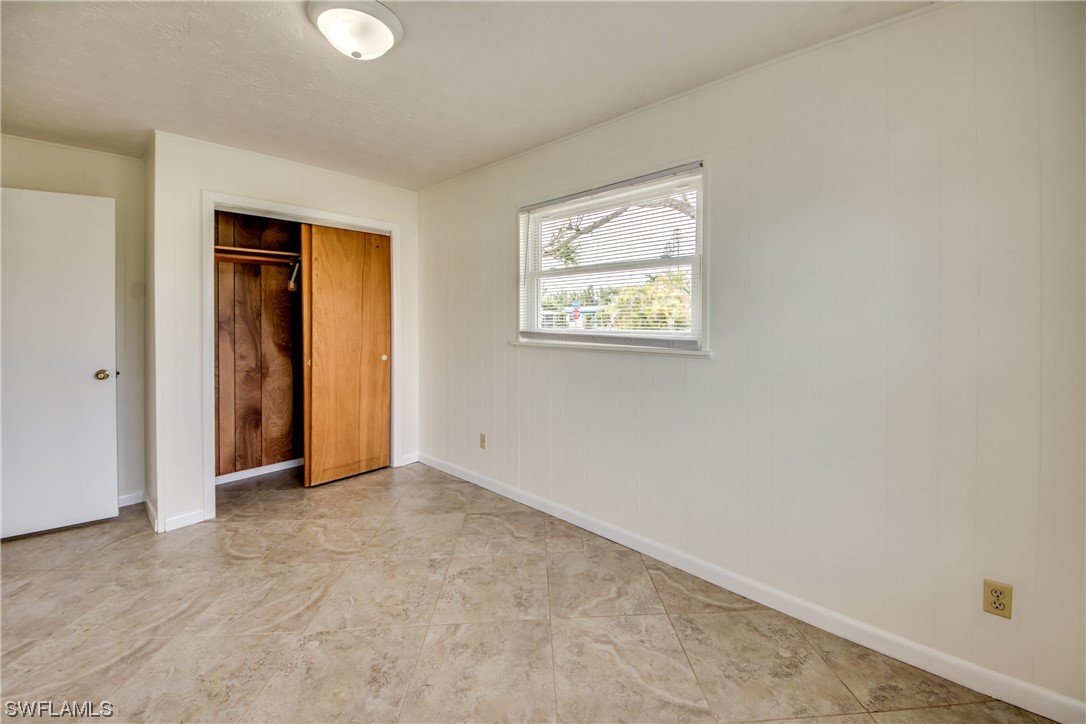 5892 Sailfish Road Bokeelia, FL 33922 - Photo 23 of 32 an empty room with windows and closet