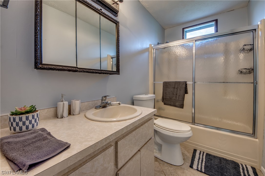 5892 Sailfish Road Bokeelia, FL 33922 - Photo 25 of 32 a bathroom with a sink toilet and shower