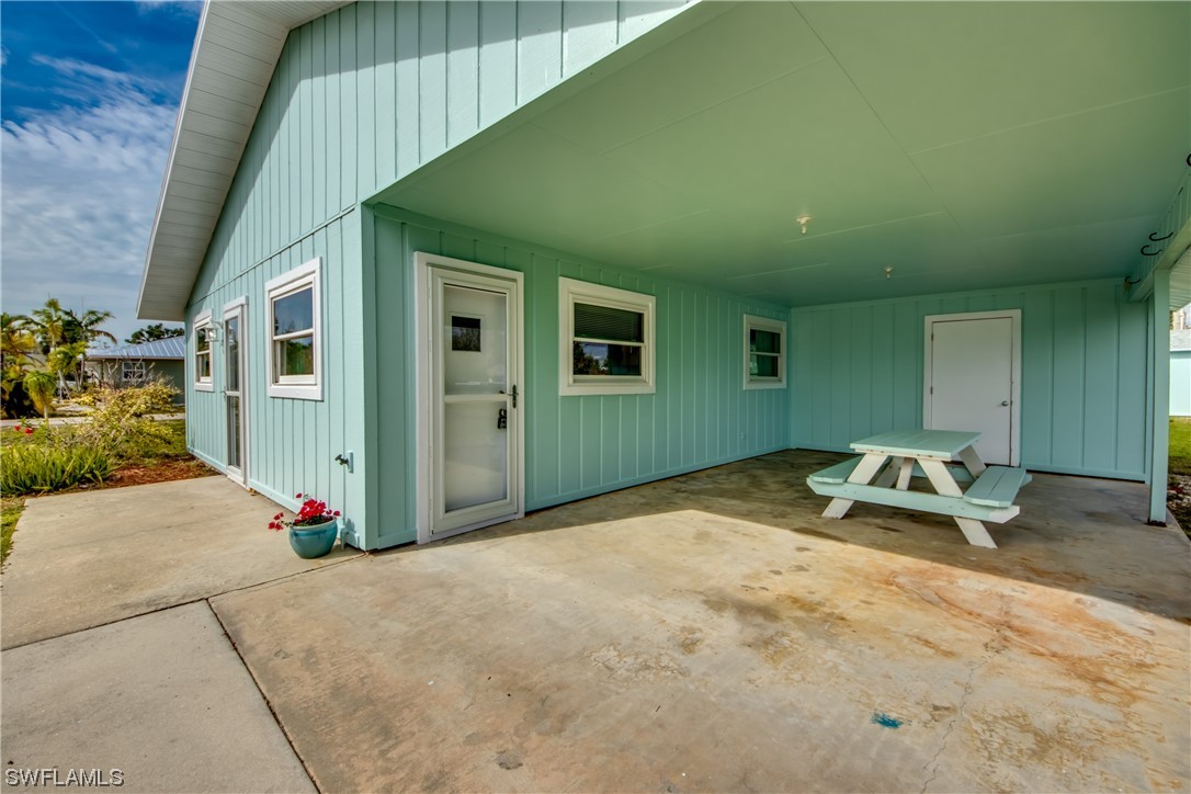 5892 Sailfish Road Bokeelia, FL 33922 - Photo 4 of 32 a backyard of a house with yard and furniture