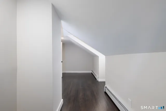 a view of hallway with wooden floor