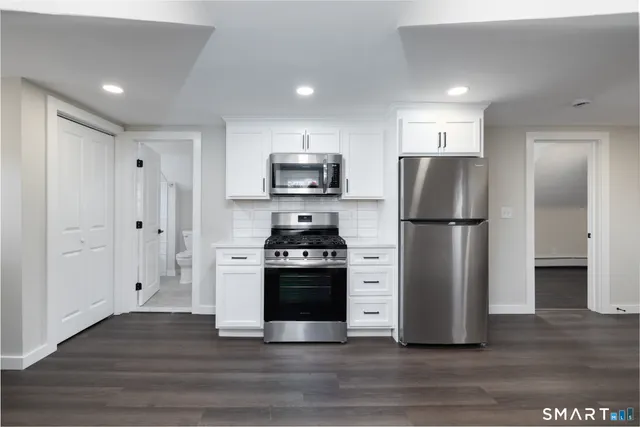 a kitchen with a refrigerator and a stove