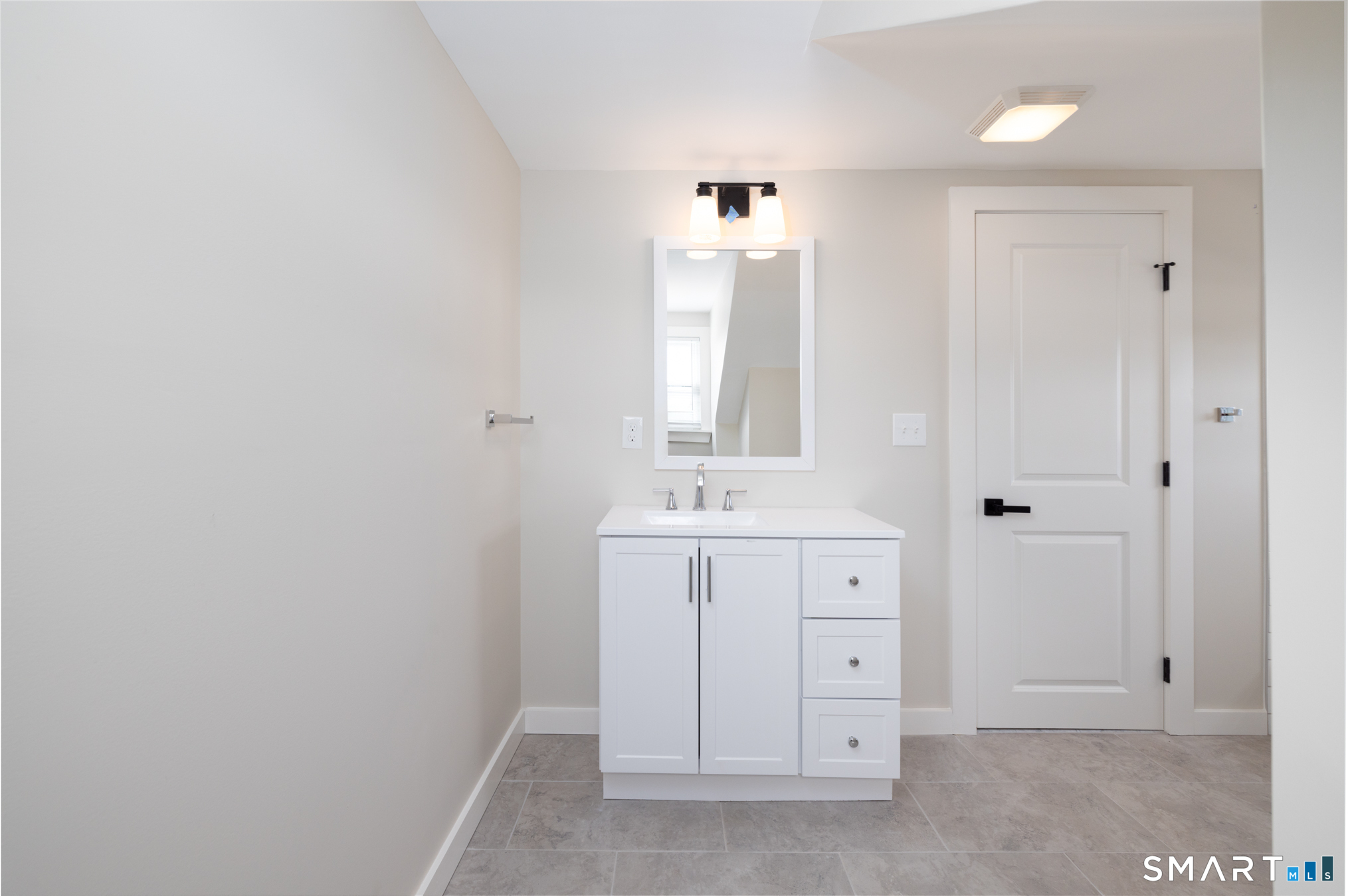28 Aircraft Road, Unit I Southington, CT 06489 - Photo 6 of 18 a spacious bathroom with a double vanity sink and a mirror