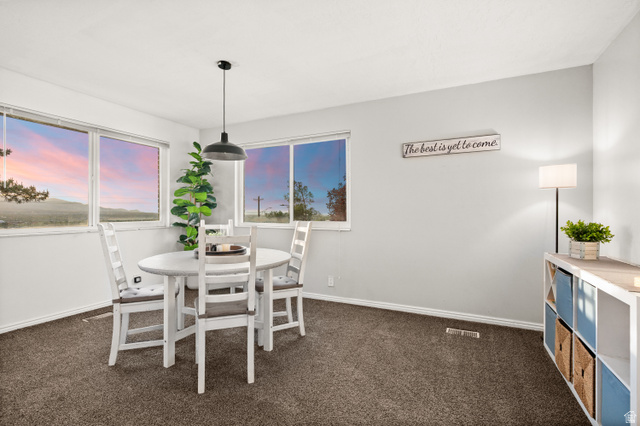 9750 Indian Ridge Drive Sandy, UT 84092 - Photo 27 of 40 Dining space with dark carpet and baseboards
