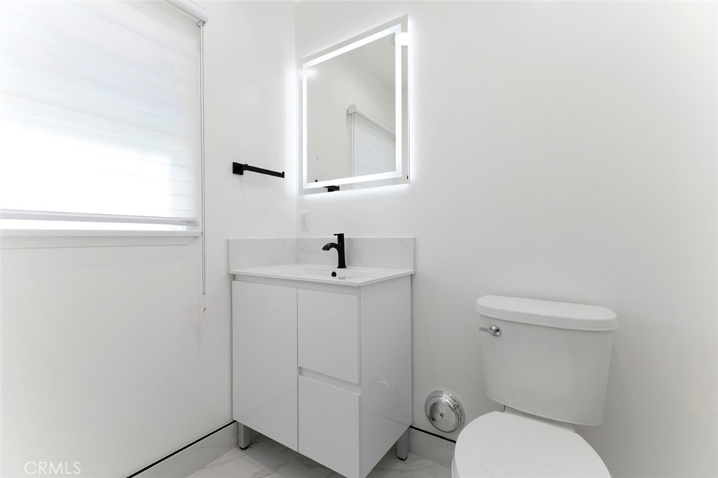 11321 Collett Avenue Granada Hills, CA 91344 - Photo 11 of 11 a white toilet sitting next to a bathroom sink