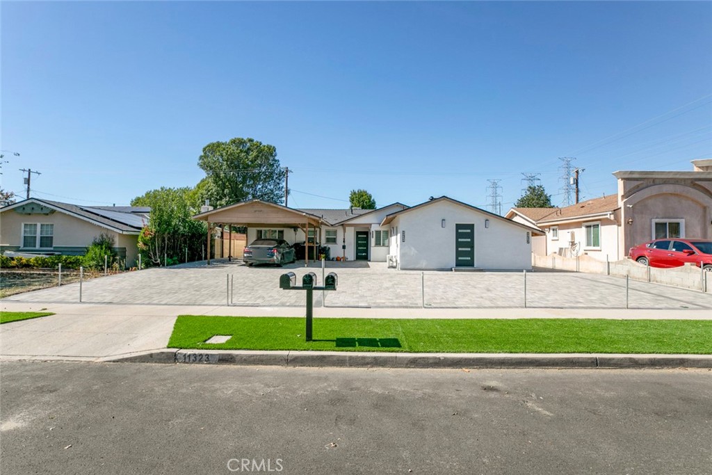 11321 Collett Avenue Granada Hills, CA 91344 - Photo 3 of 11 a front view of house with yard and green space