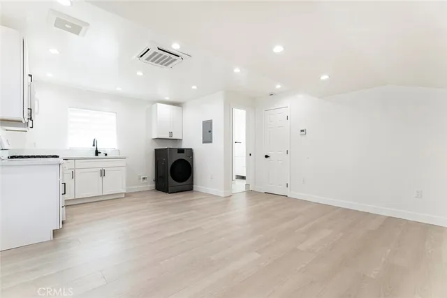 a view of a kitchen with a sink a refrigerator and window