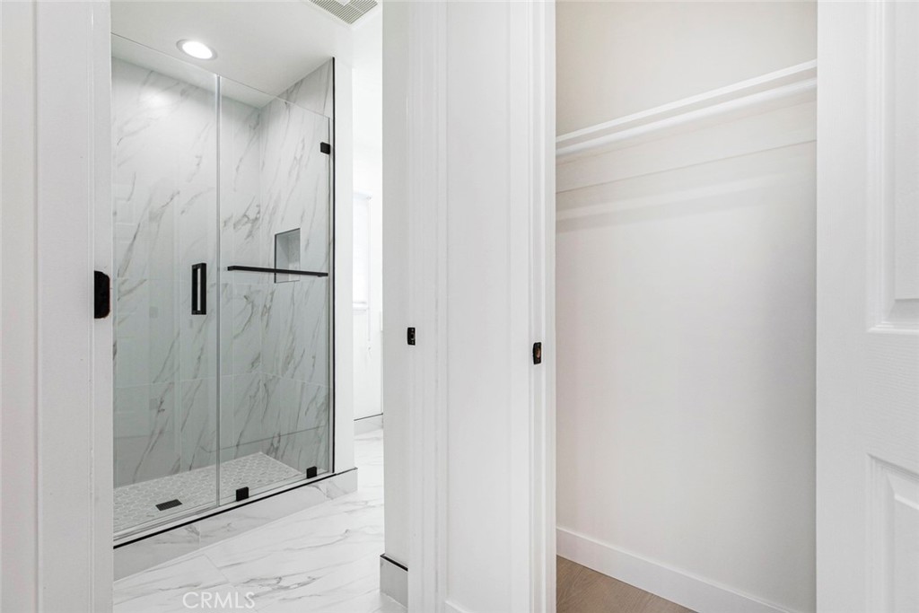 11321 Collett Avenue Granada Hills, CA 91344 - Photo 9 of 11 a bathroom with a glass shower door