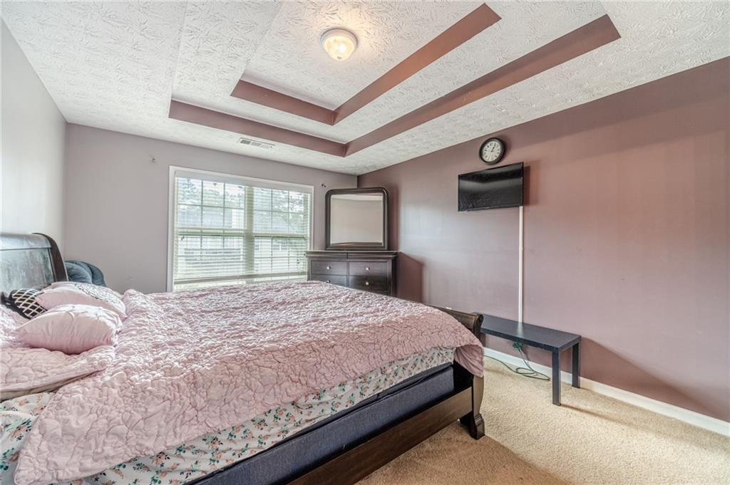 1185 Wendy Way Winder, GA 30680 - Photo 24 of 46 a bedroom with a bed and a large window