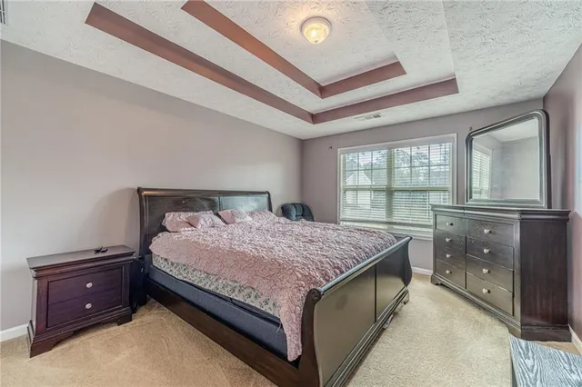 a bedroom with a bed and window with lamp