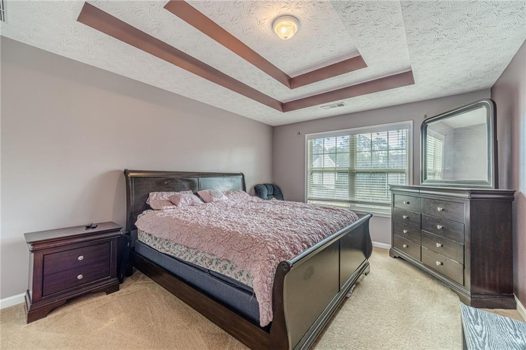 1185 Wendy Way Winder, GA 30680 - Photo 25 of 46 a bedroom with a bed and window with lamp