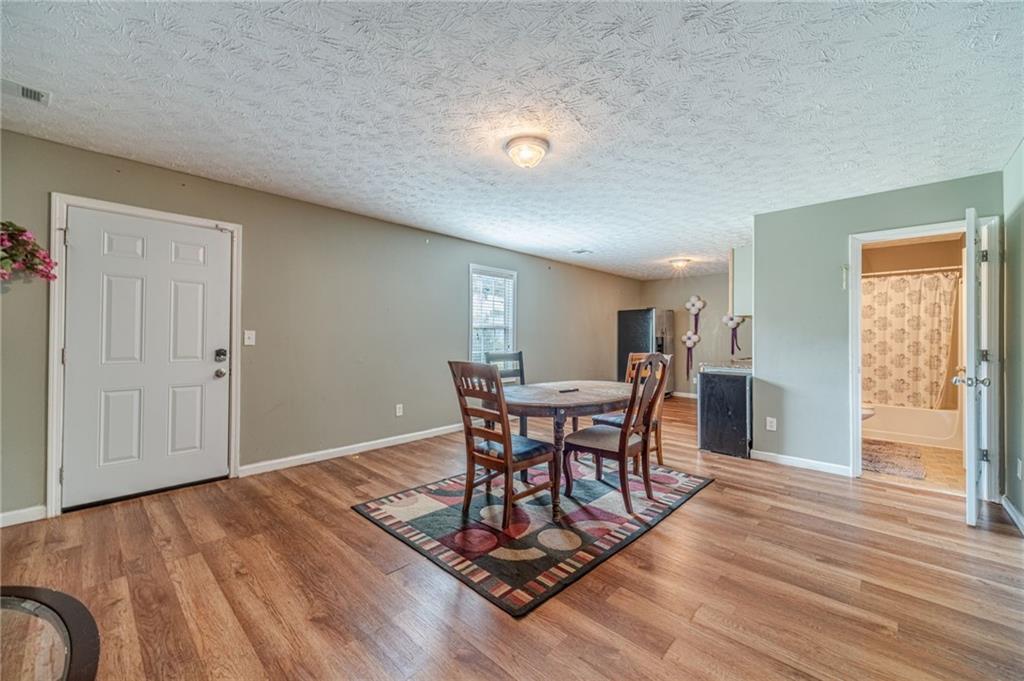 1185 Wendy Way Winder, GA 30680 - Photo 36 of 46 a view of a dining room with furniture and wooden floor