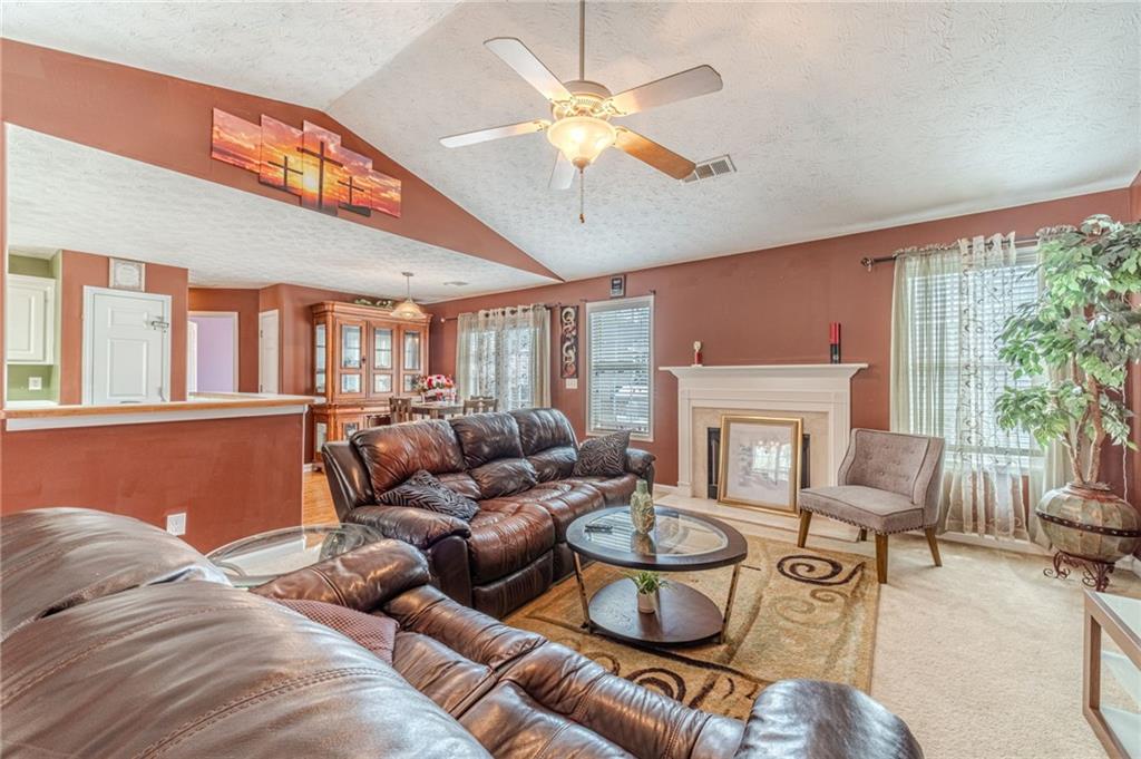 1185 Wendy Way Winder, GA 30680 - Photo 5 of 46 a living room with furniture a fireplace and a large window