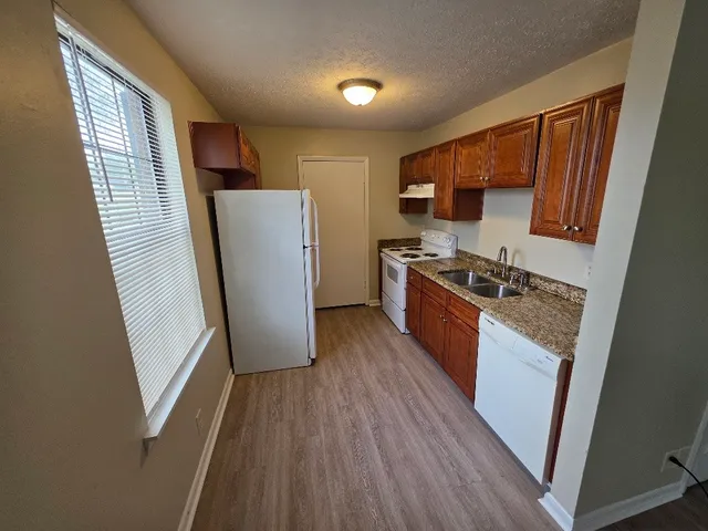 a kitchen with sink a refrigerator a washer and dryer