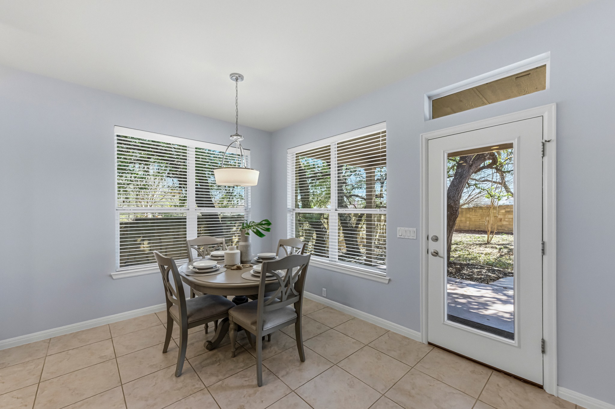 1023 Grassy Field Road Austin, TX 78737 - Photo 14 of 39 a dining room with furniture large windows and wooden floor