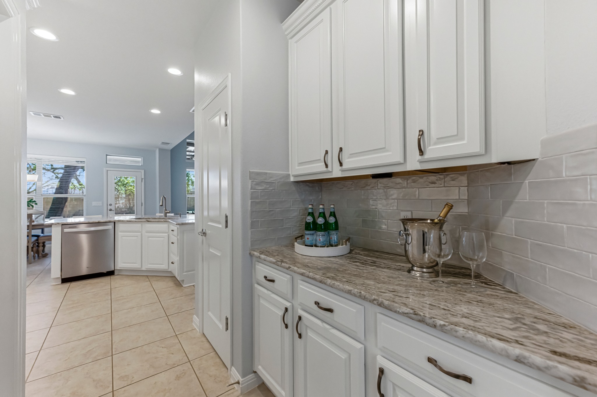 1023 Grassy Field Road Austin, TX 78737 - Photo 15 of 39 a kitchen with white cabinets and white appliances