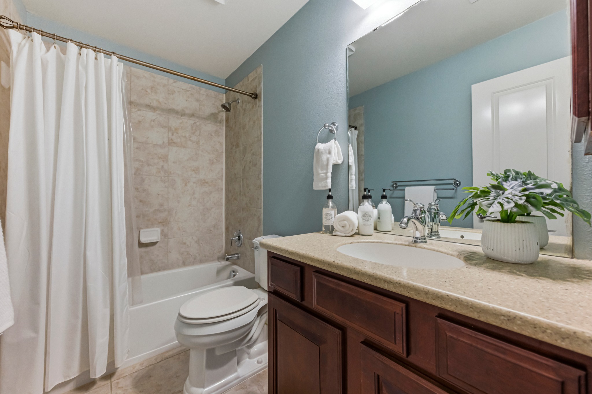 1023 Grassy Field Road Austin, TX 78737 - Photo 27 of 39 a bathroom with a granite countertop sink a toilet and shower