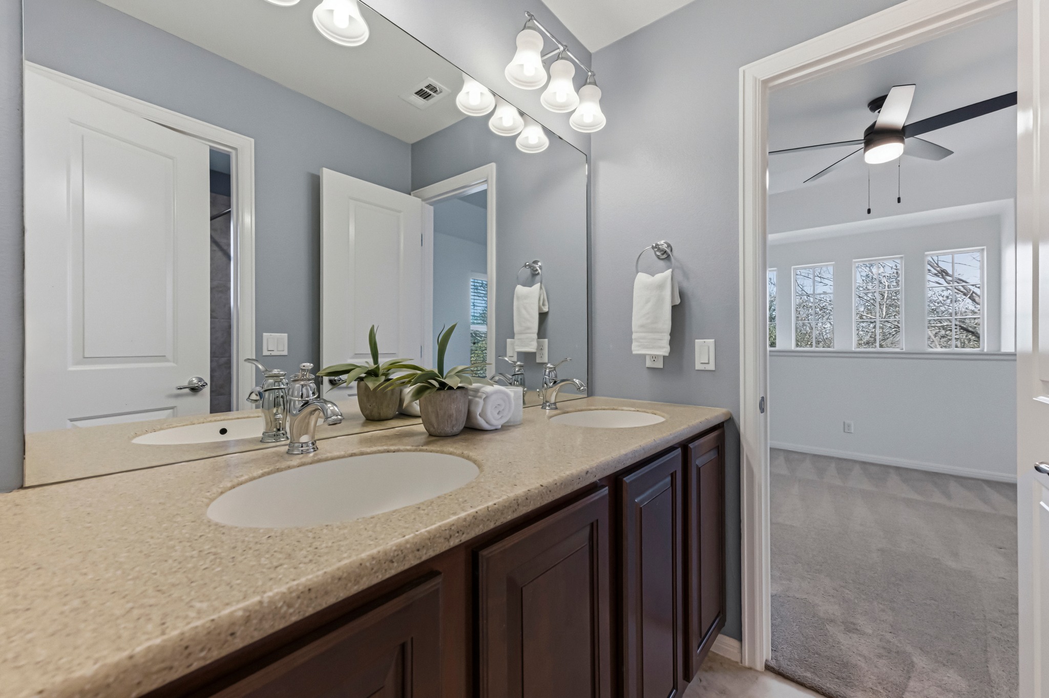 1023 Grassy Field Road Austin, TX 78737 - Photo 29 of 39 a bathroom with a granite countertop double vanity and a mirror