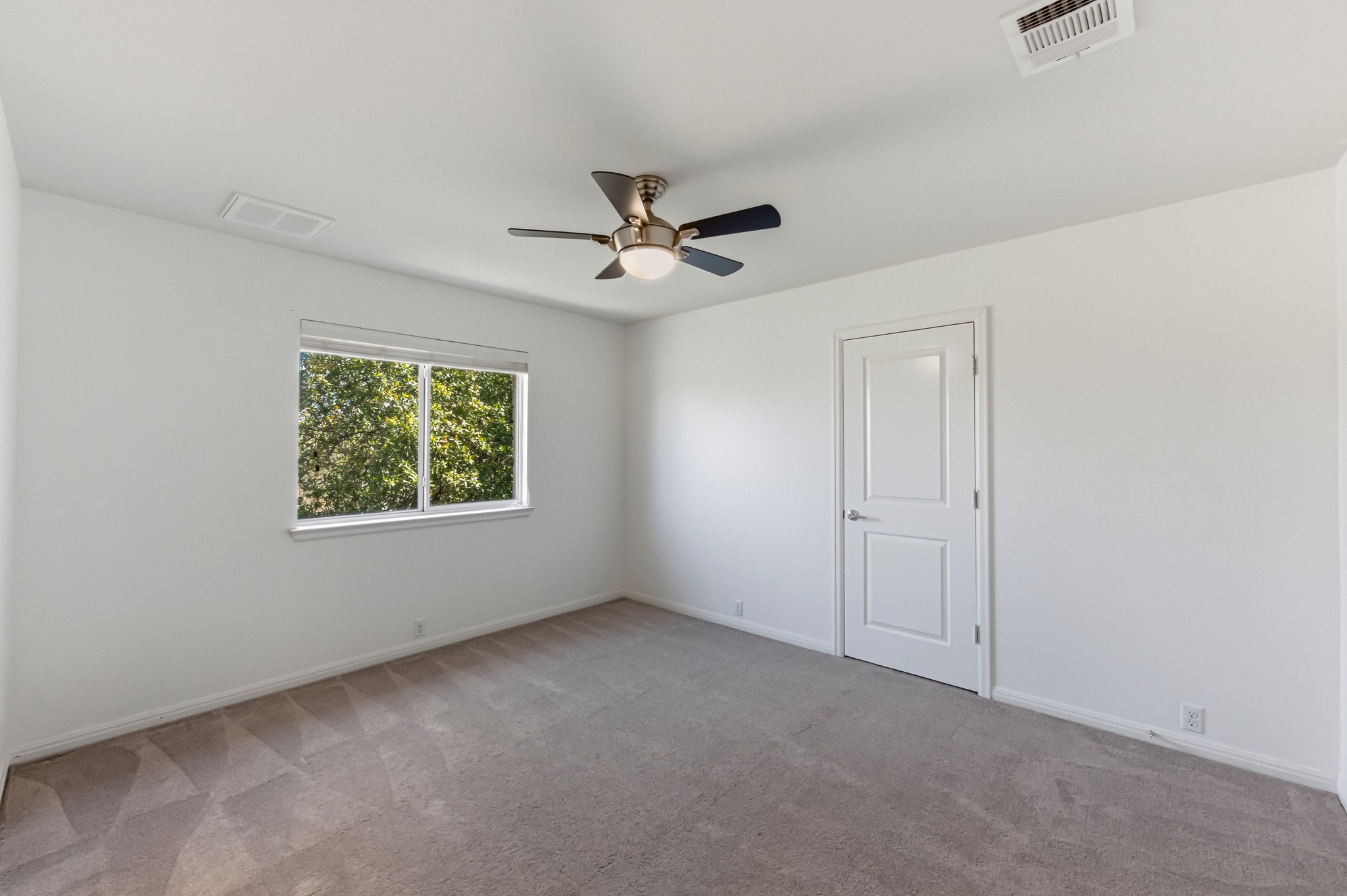 1023 Grassy Field Road Austin, TX 78737 - Photo 30 of 39 an empty room with ceiling fan and windows