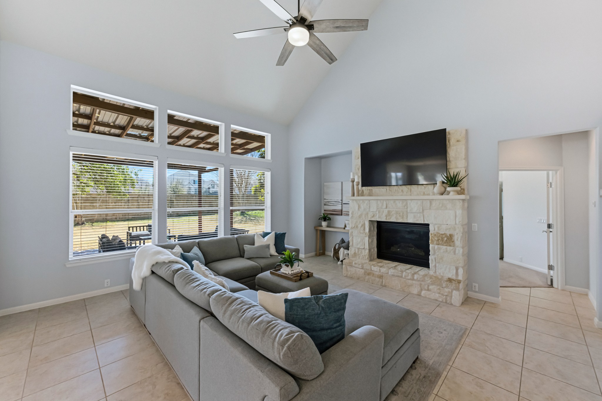 1023 Grassy Field Road Austin, TX 78737 - Photo 7 of 39 a living room with furniture a fireplace and a flat screen tv