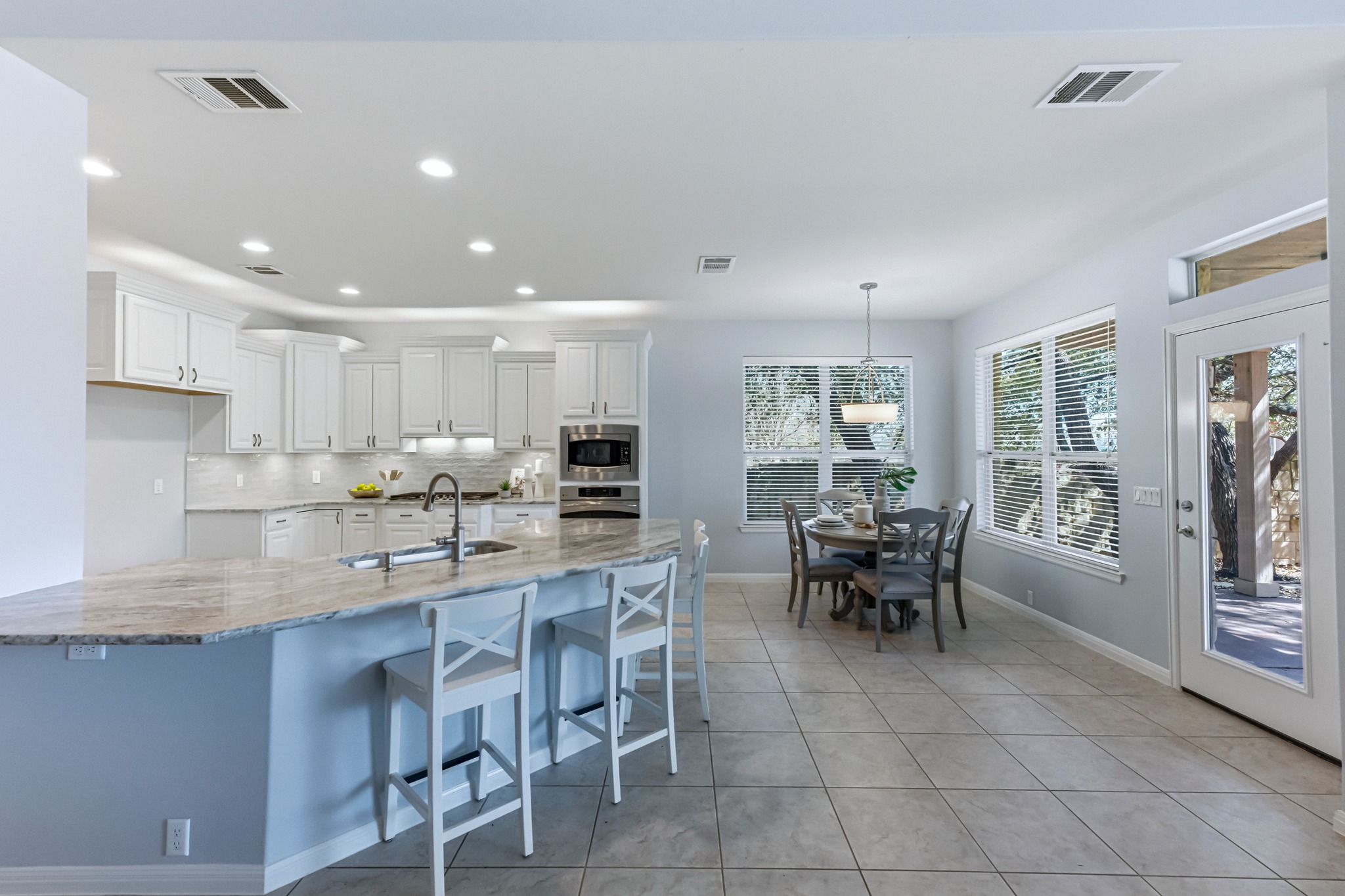 1023 Grassy Field Road Austin, TX 78737 - Photo 9 of 39 a room with stainless steel appliances kitchen island granite countertop a dining table chairs and view living room