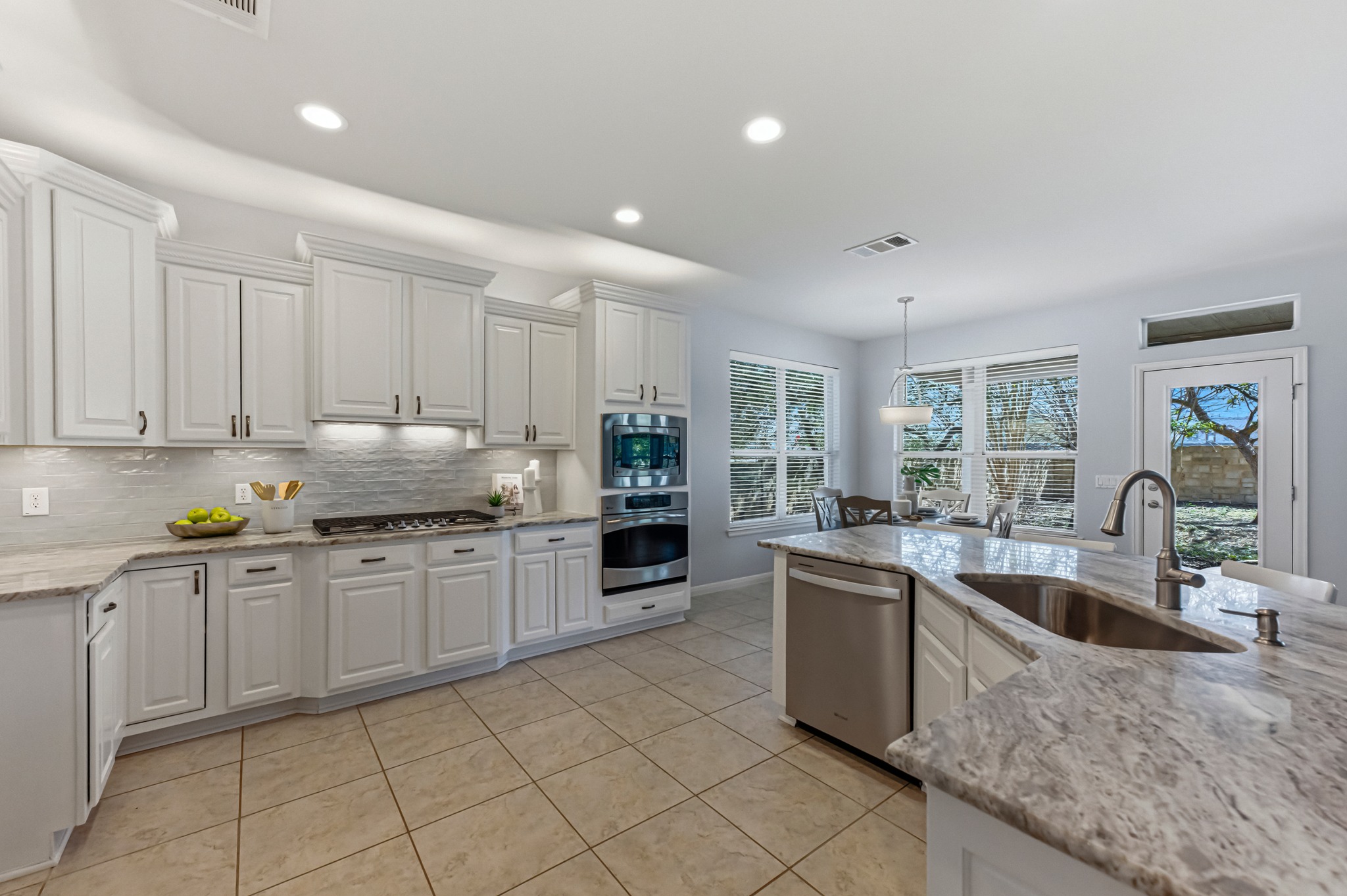 1023 Grassy Field Road Austin, TX 78737 - Photo 10 of 39 a kitchen with granite countertop stainless steel appliances a sink a counter top space cabinets and a window