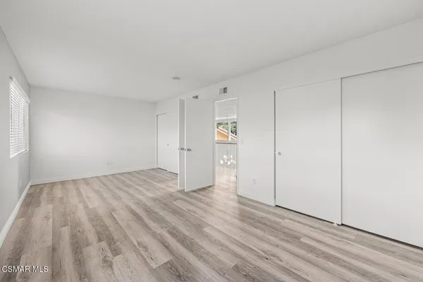 a view of an empty room and wooden floor