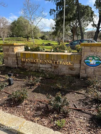 a view of street with parking and sign board
