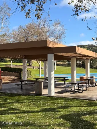 a swimming pool with outdoor seating and yard