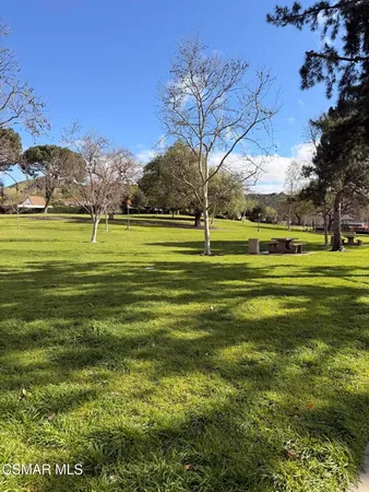 a view of a big yard with a fountain