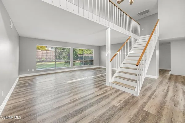 a view of an entryway with wooden floor