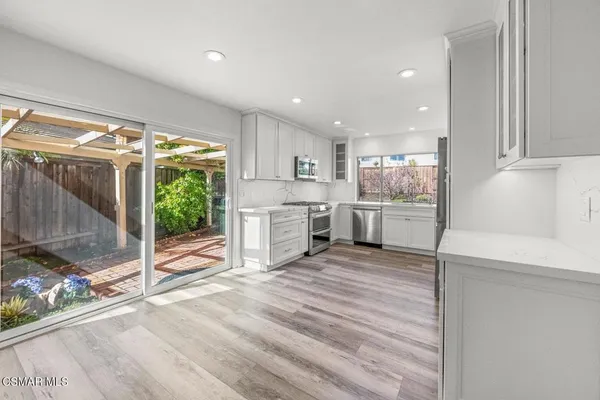 a view of a kitchen with a sink and cabinets