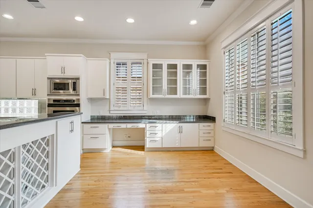 a view of large kitchen with wooden floor and center dining table