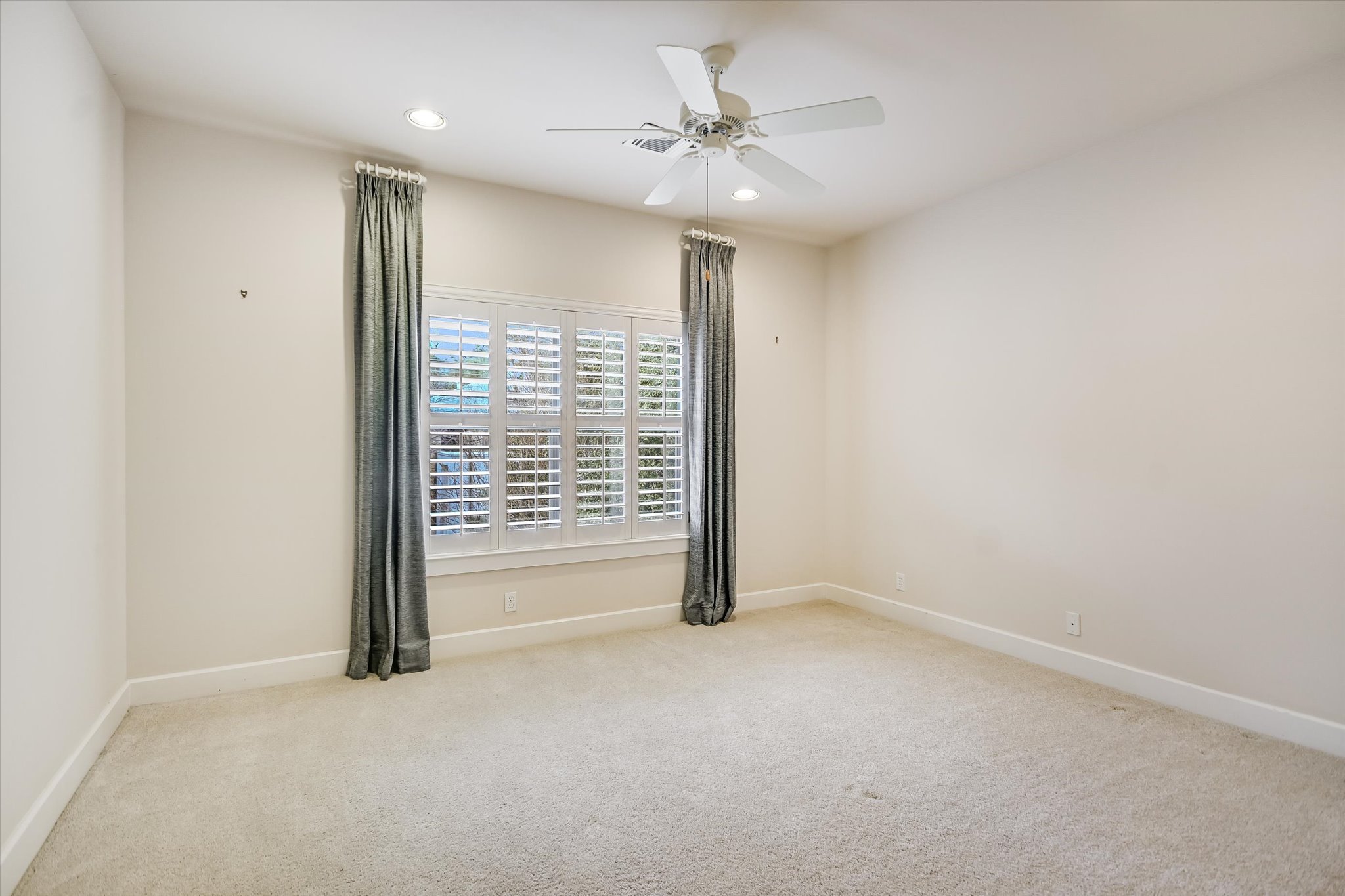 703 Pressler Street Austin, TX 78703 - Photo 17 of 24 an empty room with a ceiling fan and a window