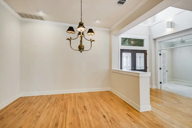 a view of a room with wooden floor and ceiling fan