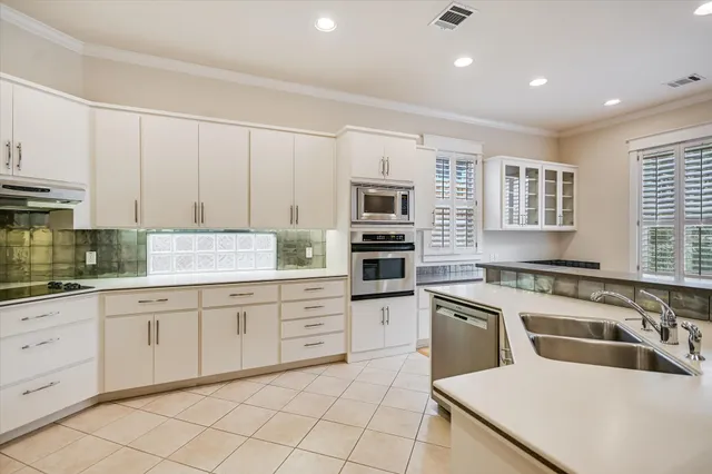 a large kitchen with stainless steel appliances granite countertop a granite counter tops and a window