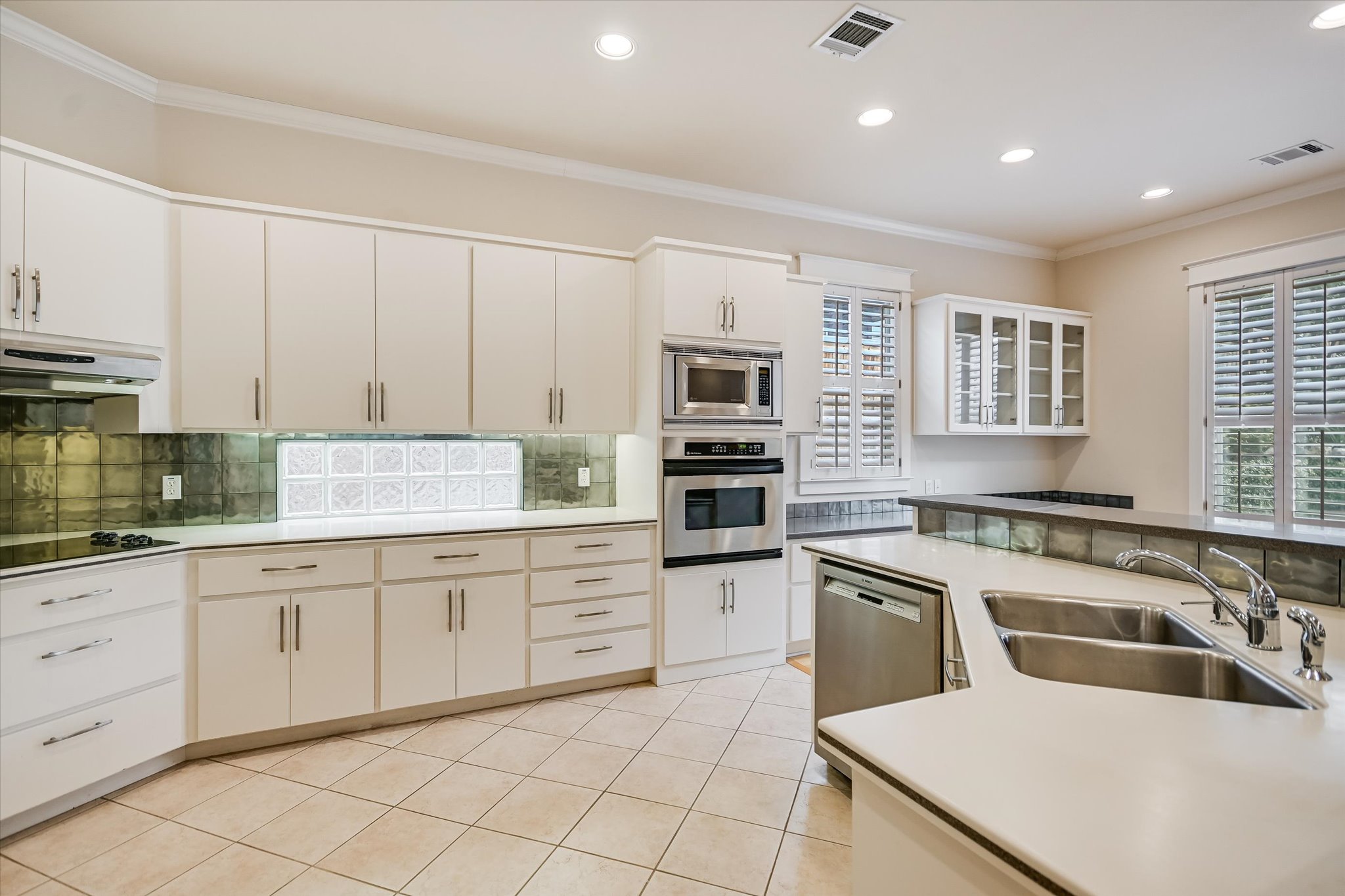 703 Pressler Street Austin, TX 78703 - Photo 10 of 24 a kitchen with granite countertop white cabinets and white appliances