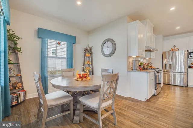 a dining room with furniture and wooden floor