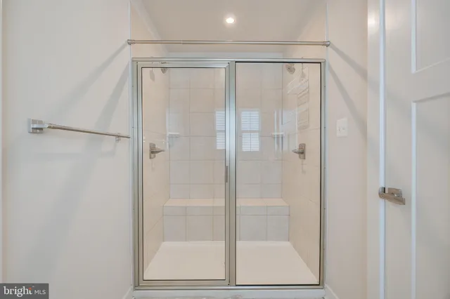 a bathroom with a glass shower door