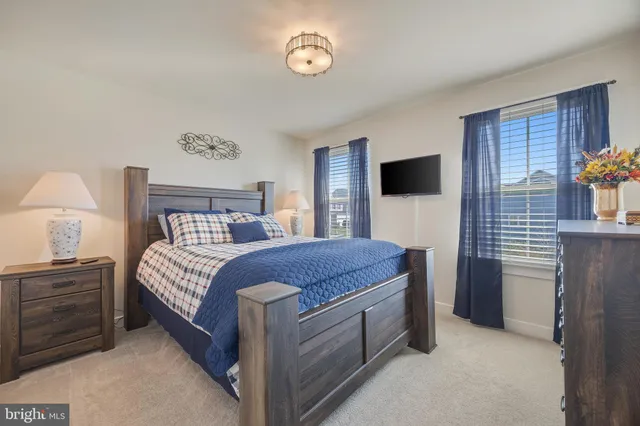 a bedroom with a bed and a tv on table