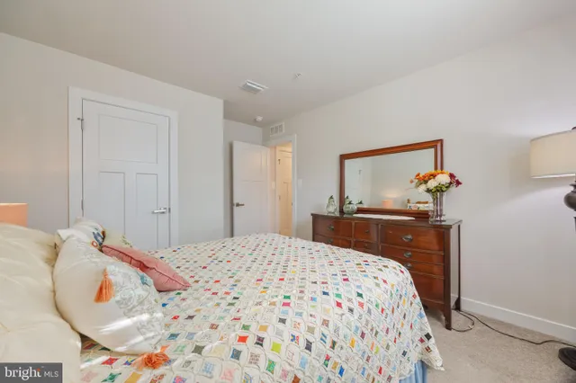 a bedroom with a bed and a dresser in it