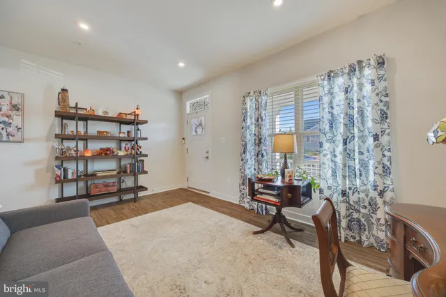a living room with furniture and a bookshelf