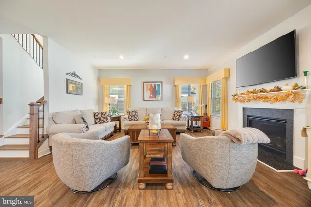 a living room with fireplace furniture and a flat screen tv