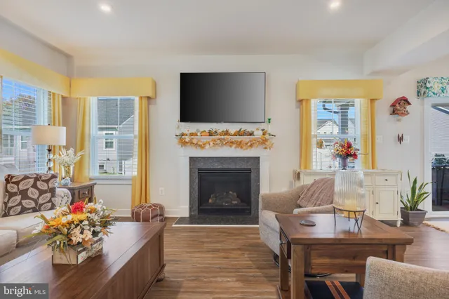 a living room with furniture fireplace and flat screen tv