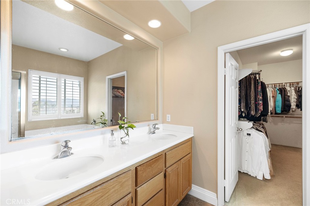 32921 Adelante Street Temecula, CA 92592 - Photo 25 of 48 a bathroom with a double vanity sink a and mirror