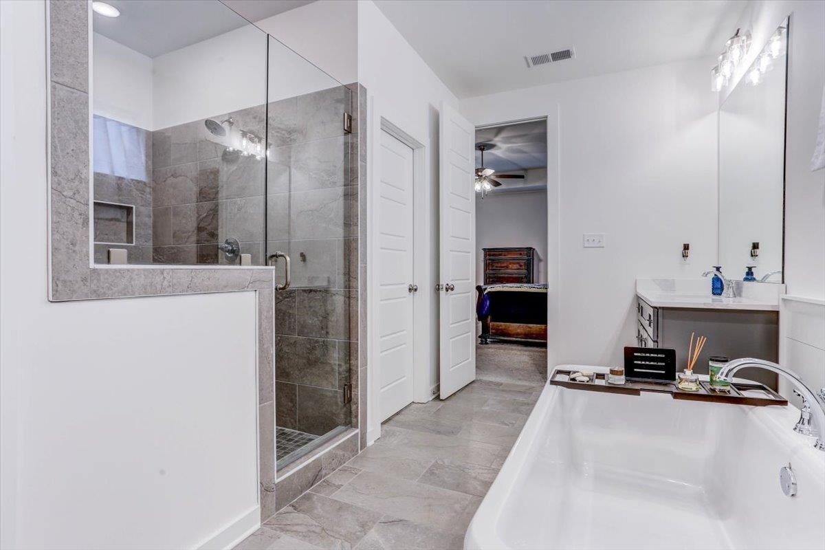 810 Mebane Road Oakland, TN 38060 - Photo 13 of 27 a view of a bathroom with a tub and shower