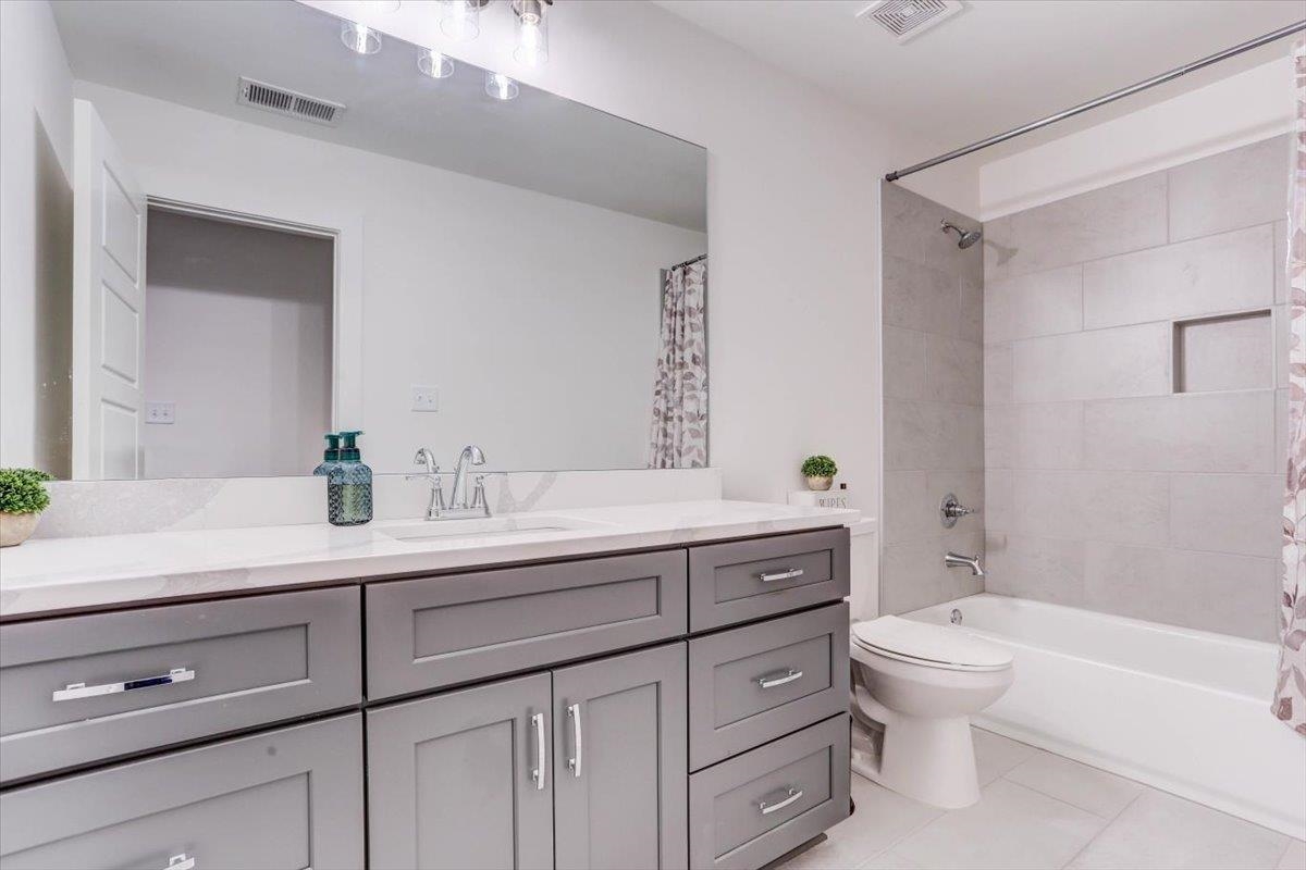 810 Mebane Road Oakland, TN 38060 - Photo 18 of 27 a bathroom with a toilet a sink a tub and mirror