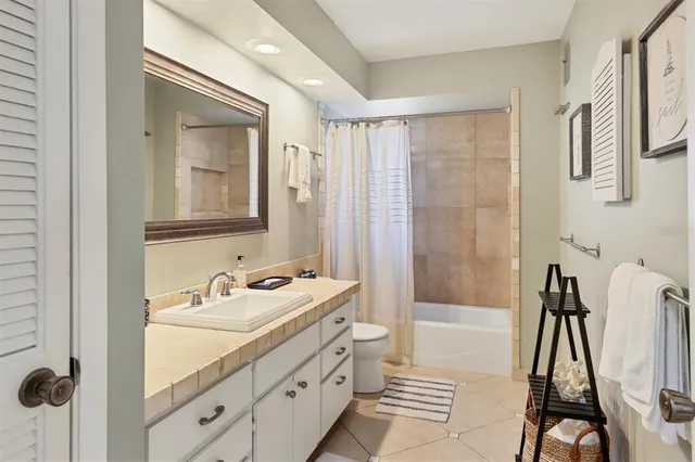 a bathroom with a sink a mirror and a shower